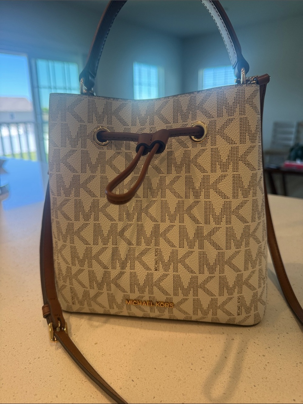 Michael Kors Cream Logo Drawstring Crossbody Brown Trim Gently used, no flaws